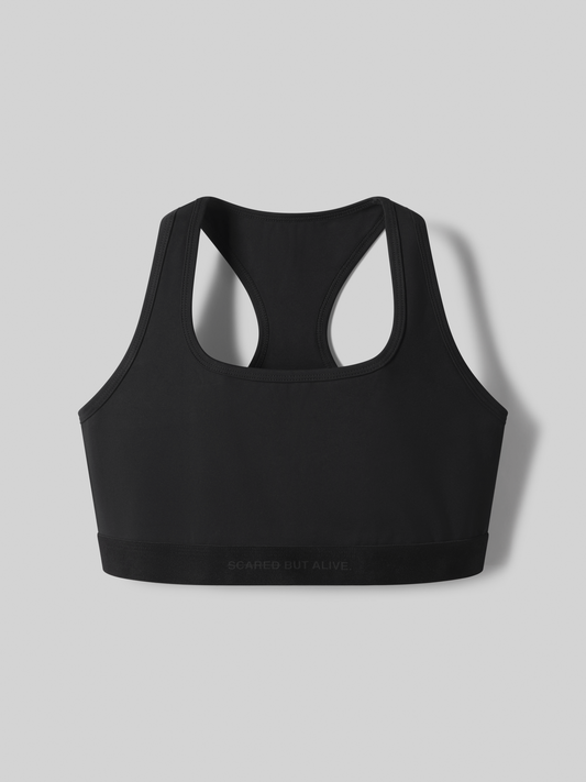 Black sports bra with "Scared But Alive" logo on the bottom front