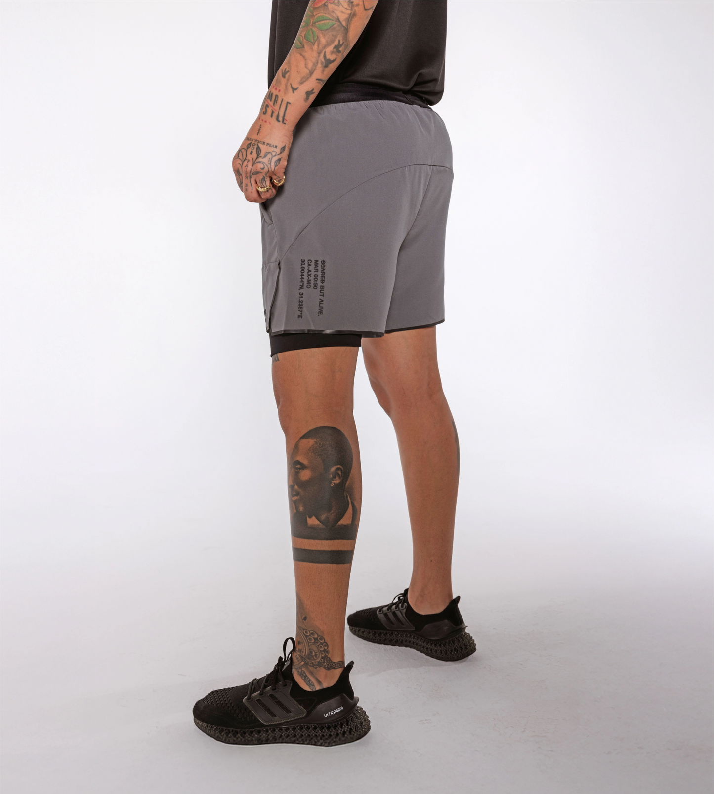 [Color: Carbon Gray] an angled view of the model wearing the Berlin Shorts