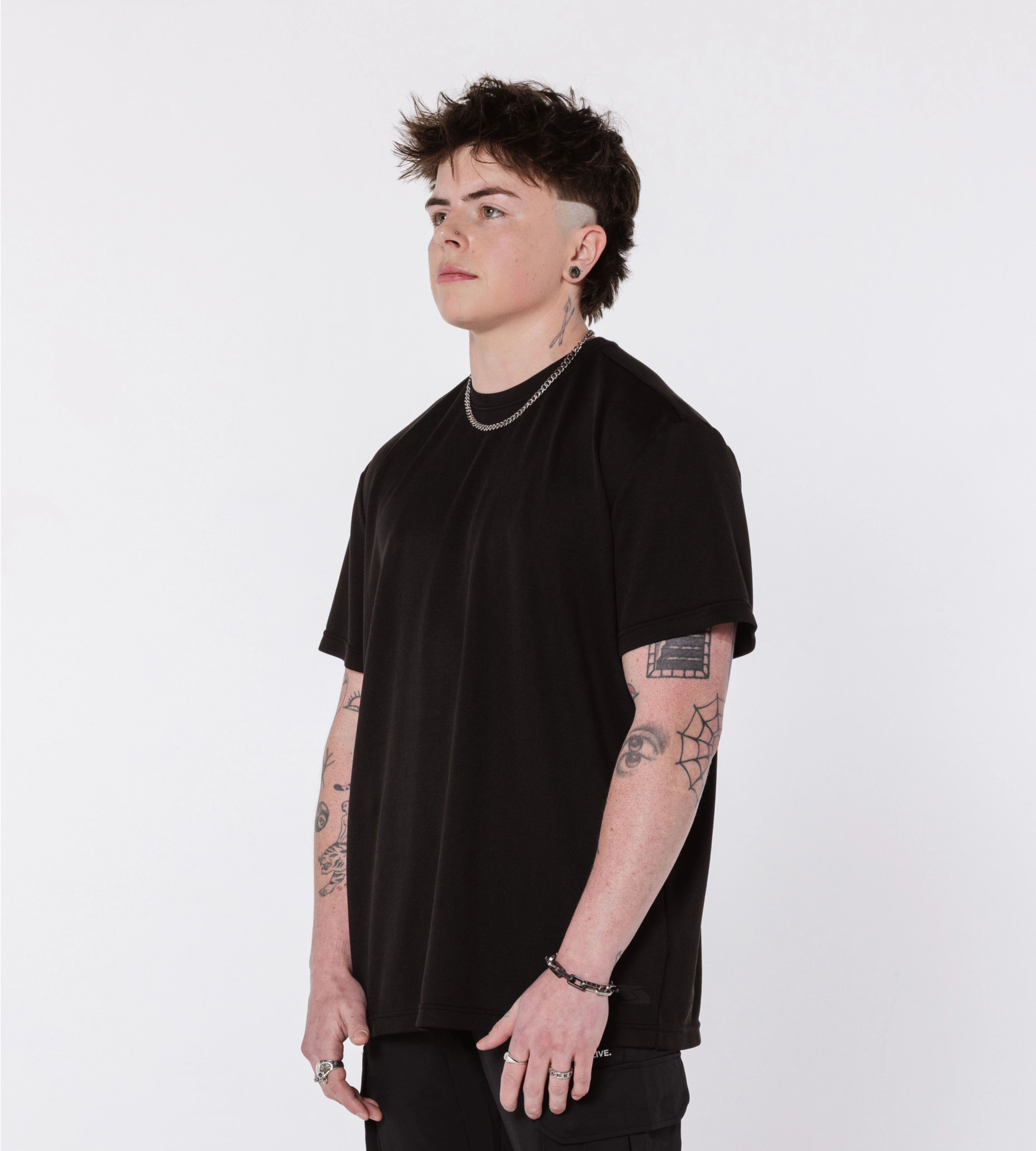 [Color: Black Out] Model wearing the Scared But Alive Bristol tee in an angled position