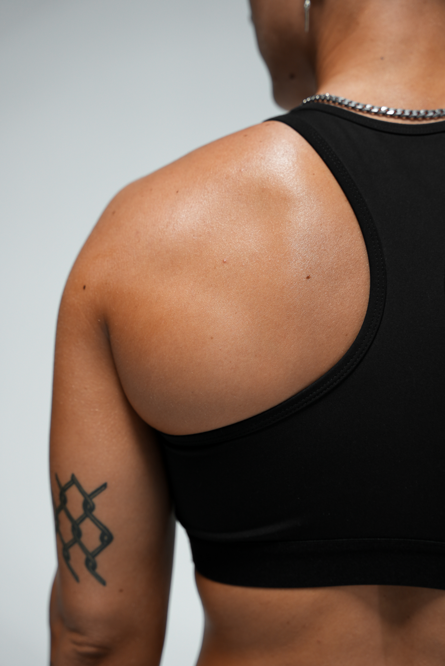 Sydney Sports Bra - closeup of back left shoulder on model