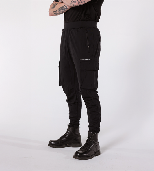 [Color: Black Out] Model wearing the Dubai Cargo Joggers in an angled position