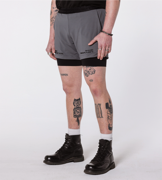 [Color: Carbon Gray] an angled view of the model wearing the Hawaii Shorts