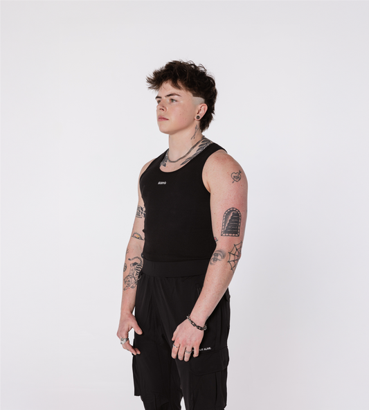 [Color: Black Out] An angled view of the model wearing the Ibiza Rib Tank and the Dubai Cargo Joggers