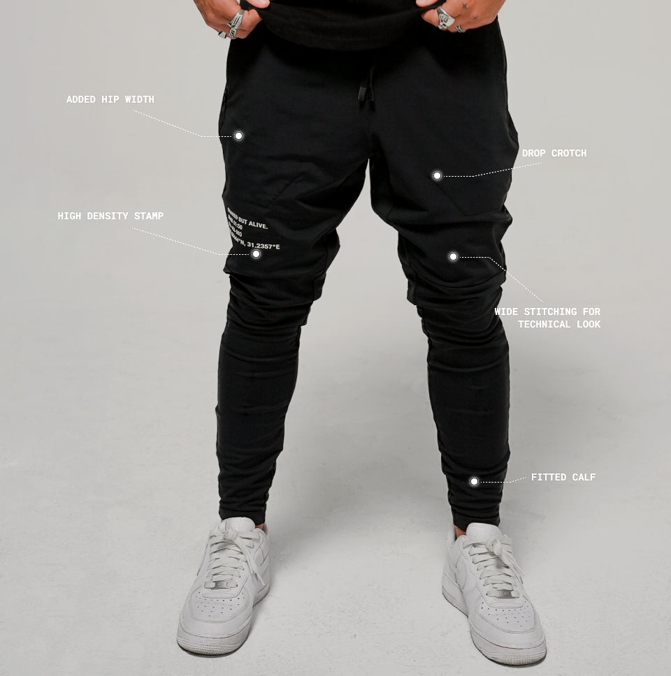 Tokyo Jogger - front view with specs: added hip width, high density stamp, drop crotch, wide stitching for technical look, fitted calf
