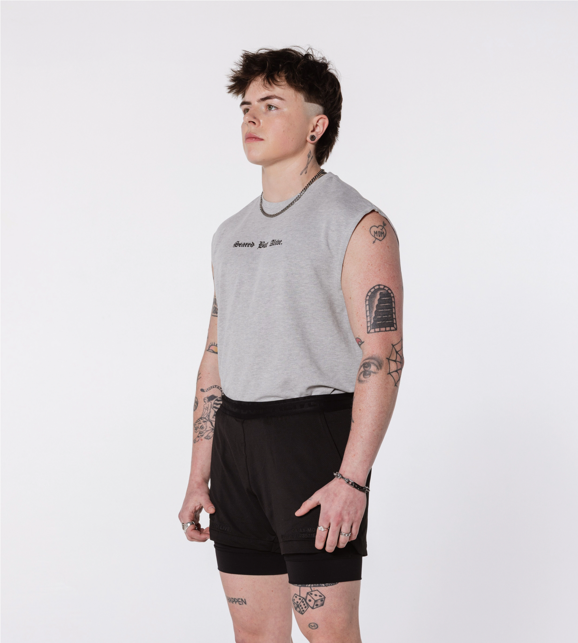 [Color: Shadow Heather] An angled image of the model wearing the London Tank and the Berlin Shorts