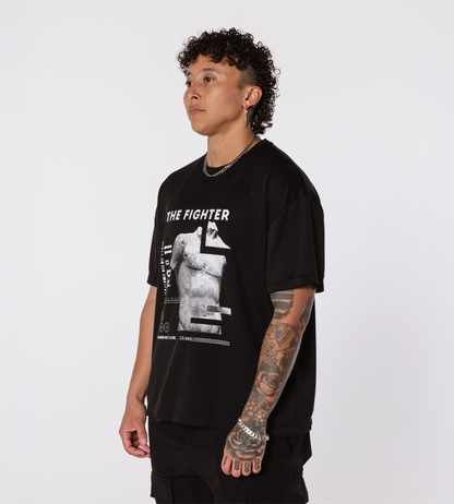 [Color: Black Out] Model wearing the Rome Fighter Tee, in an angled position