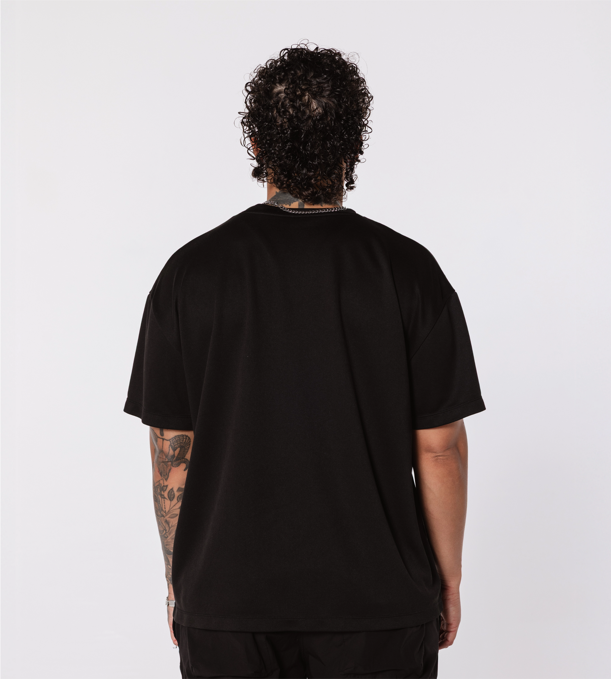 [Color: Black Out] Model facing the back, wearing the Rome Fighter Tee