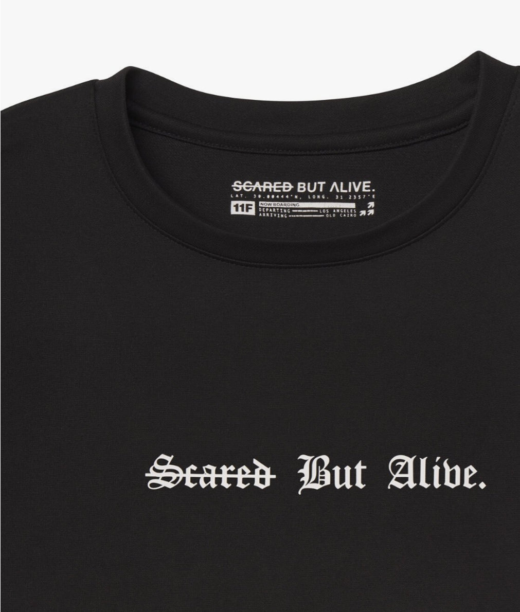 [Color: Black Out] A flat lay image of the London Tank, zoomed into the Scared But Alive logo print
