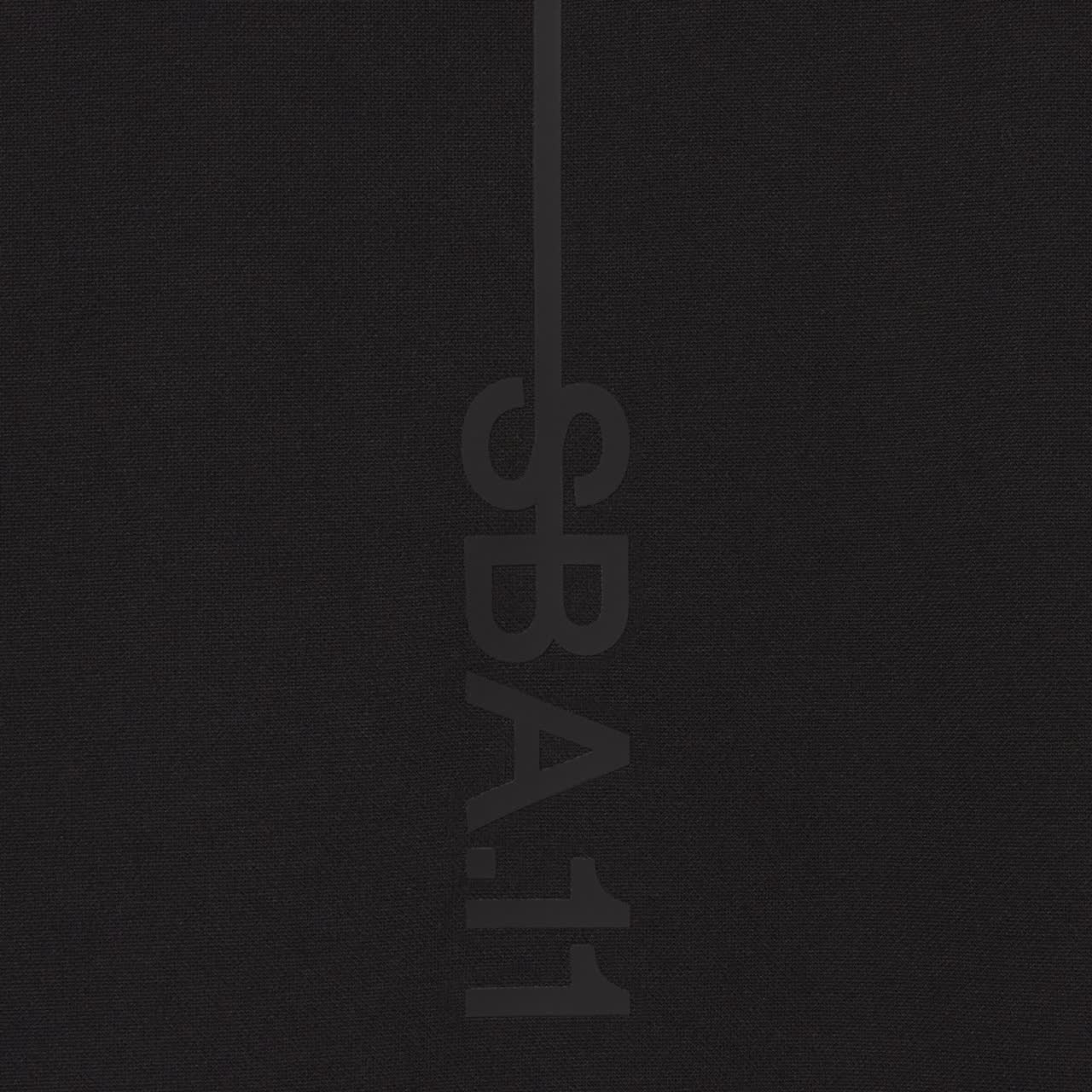 Close detail of black COMF+ piqued fabric and tonal raised print