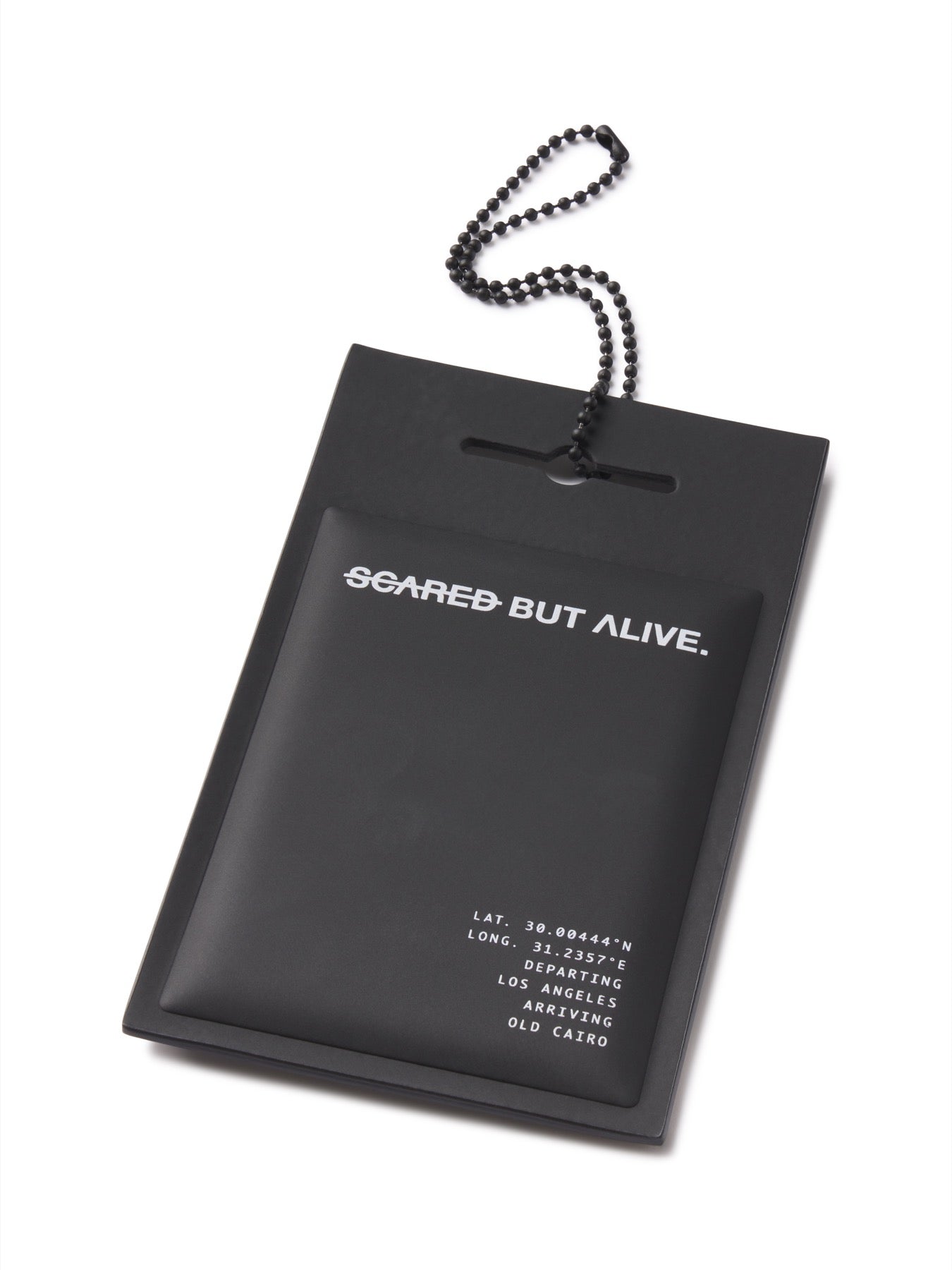 Angled close view of the Scared But Alive matte PU hang tag and chain