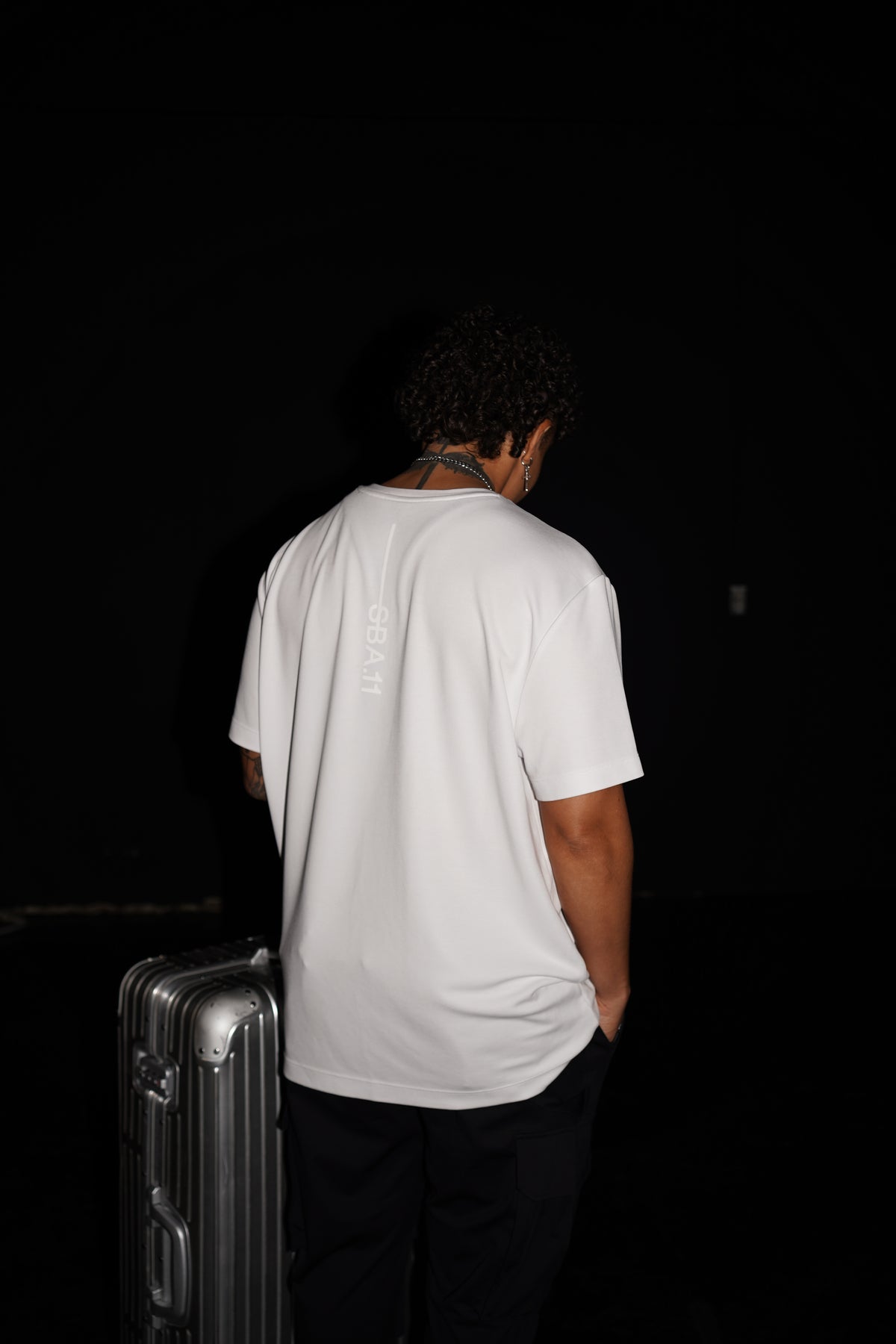 Bristol Tee White Space back fit flash photo with suitcase