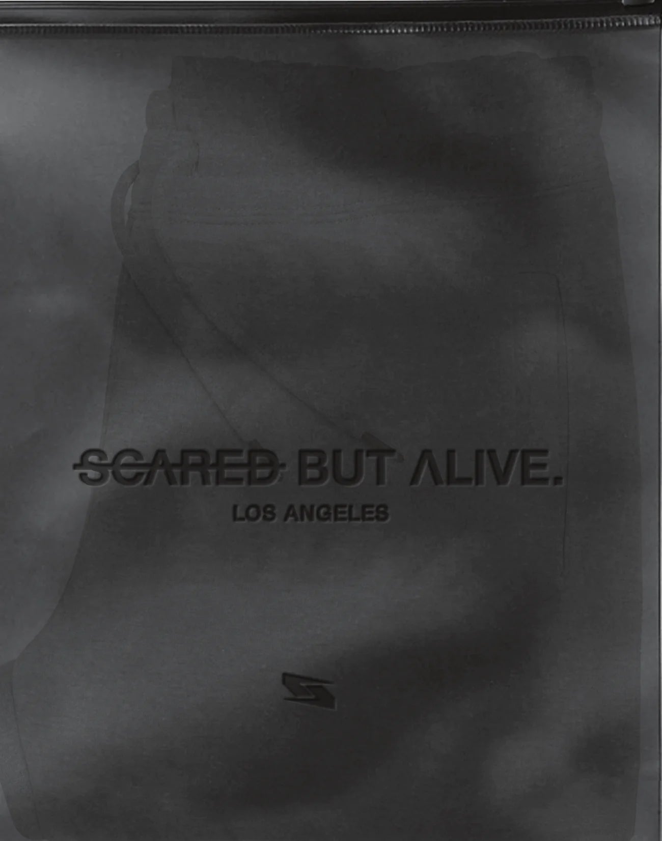Smoky frosted TPU Scared But Alive packaging with tonal mark