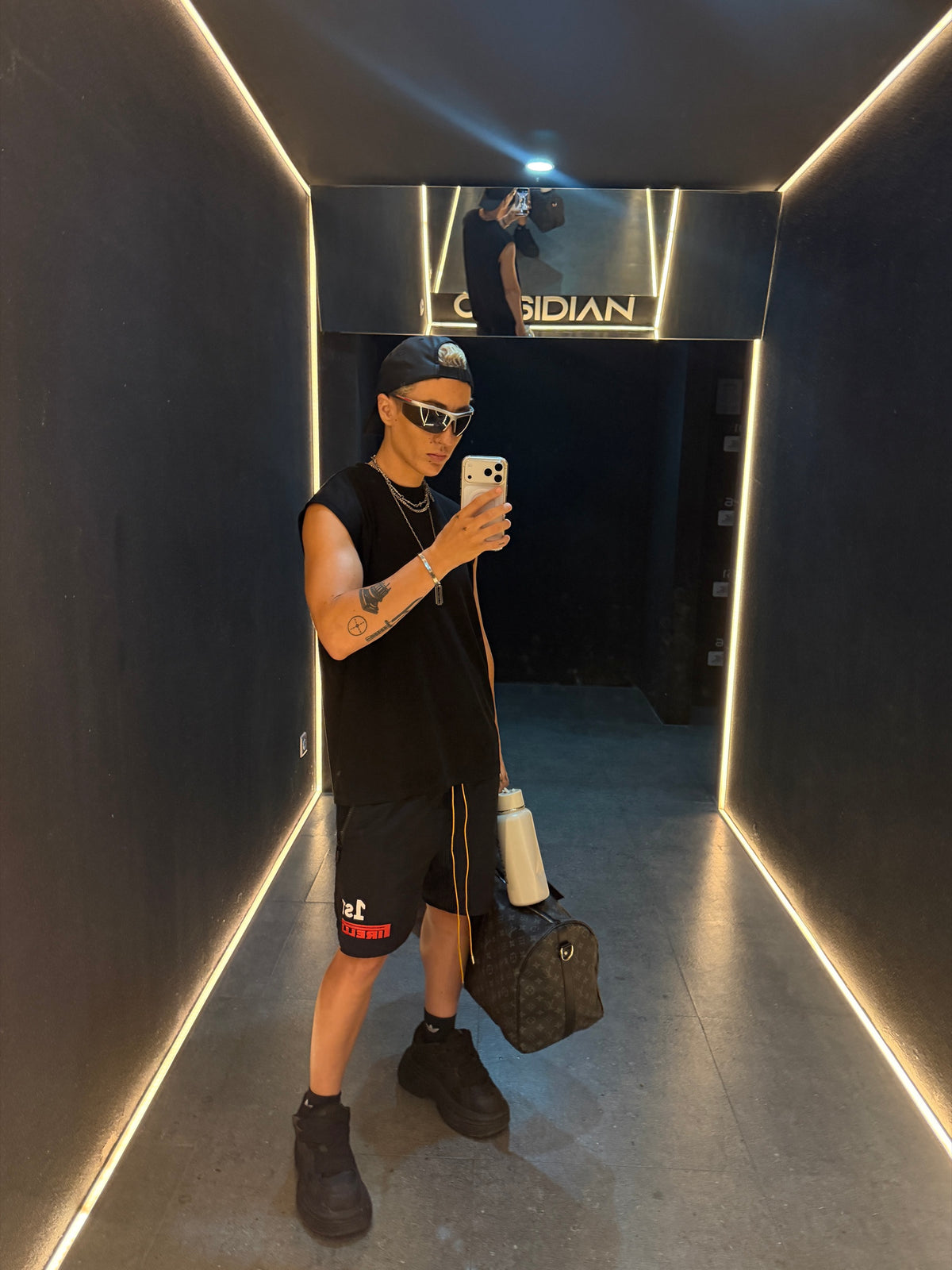 Stockholm Tank Black Out worn in low light lounge duo