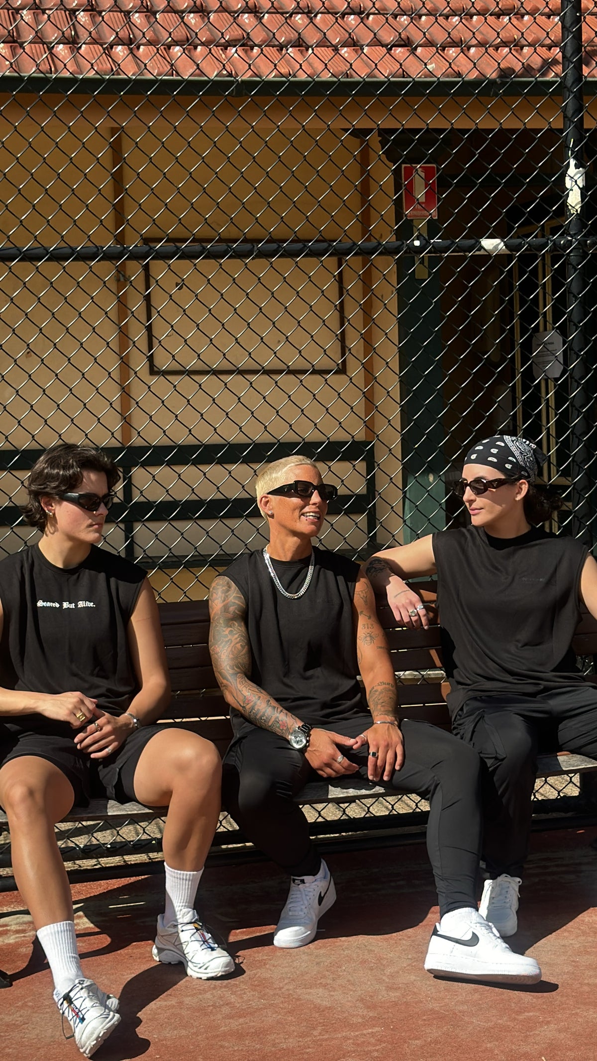 Stockholm Tank Black Out worn on bench with group