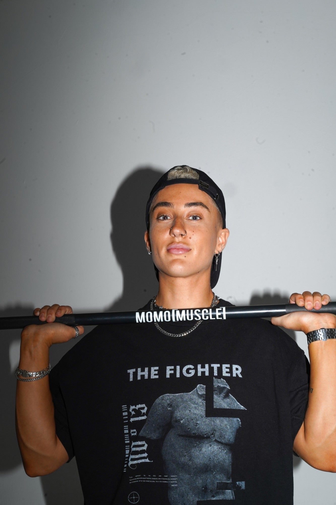 The Fighter Tee worn with a MoMo Muscle bar across the shoulders